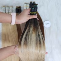 Hand holding long hair extensions