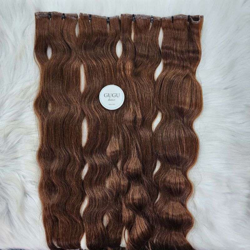 Brown wavy Genius Weft hair extensions by GUGU Hair